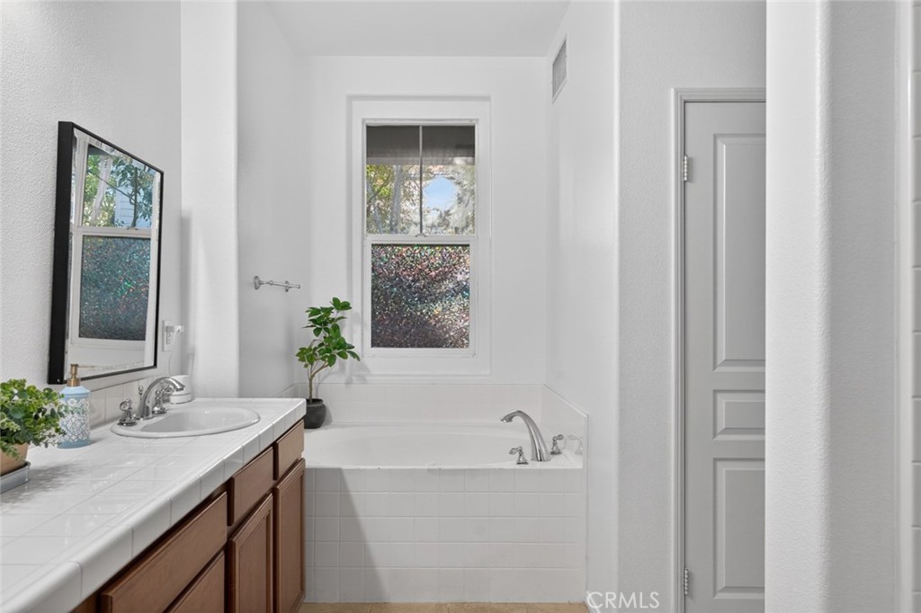 14 Valmont Way Ladera Ranch, CA 92694 - Photo 23 of 39 a bathroom with a tub sink and mirror
