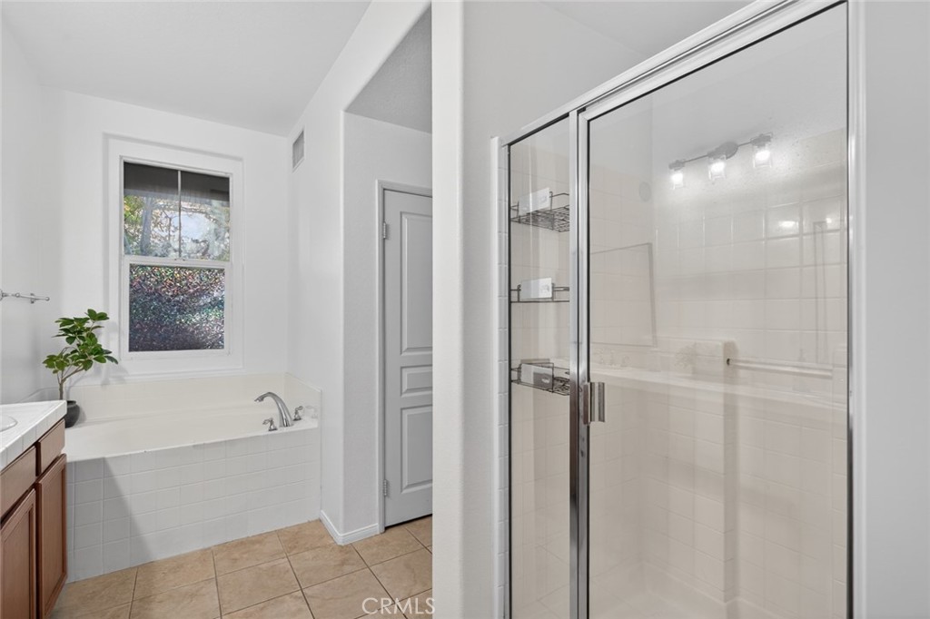 14 Valmont Way Ladera Ranch, CA 92694 - Photo 24 of 39 a bathroom with a shower and a bath tub