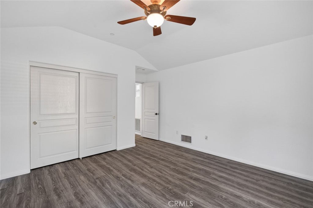 14 Valmont Way Ladera Ranch, CA 92694 - Photo 29 of 39 an empty room with wooden floor chandelier fan and windows