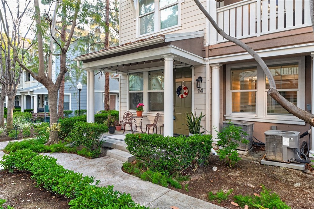 14 Valmont Way Ladera Ranch, CA 92694 - Photo 32 of 39 front view of a brick house with a large window and potted plants