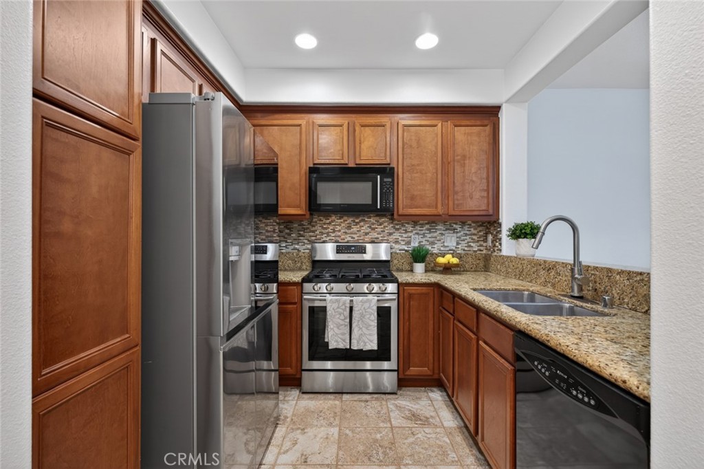 14 Valmont Way Ladera Ranch, CA 92694 - Photo 10 of 39 a kitchen with stainless steel appliances granite countertop a refrigerator stove and sink