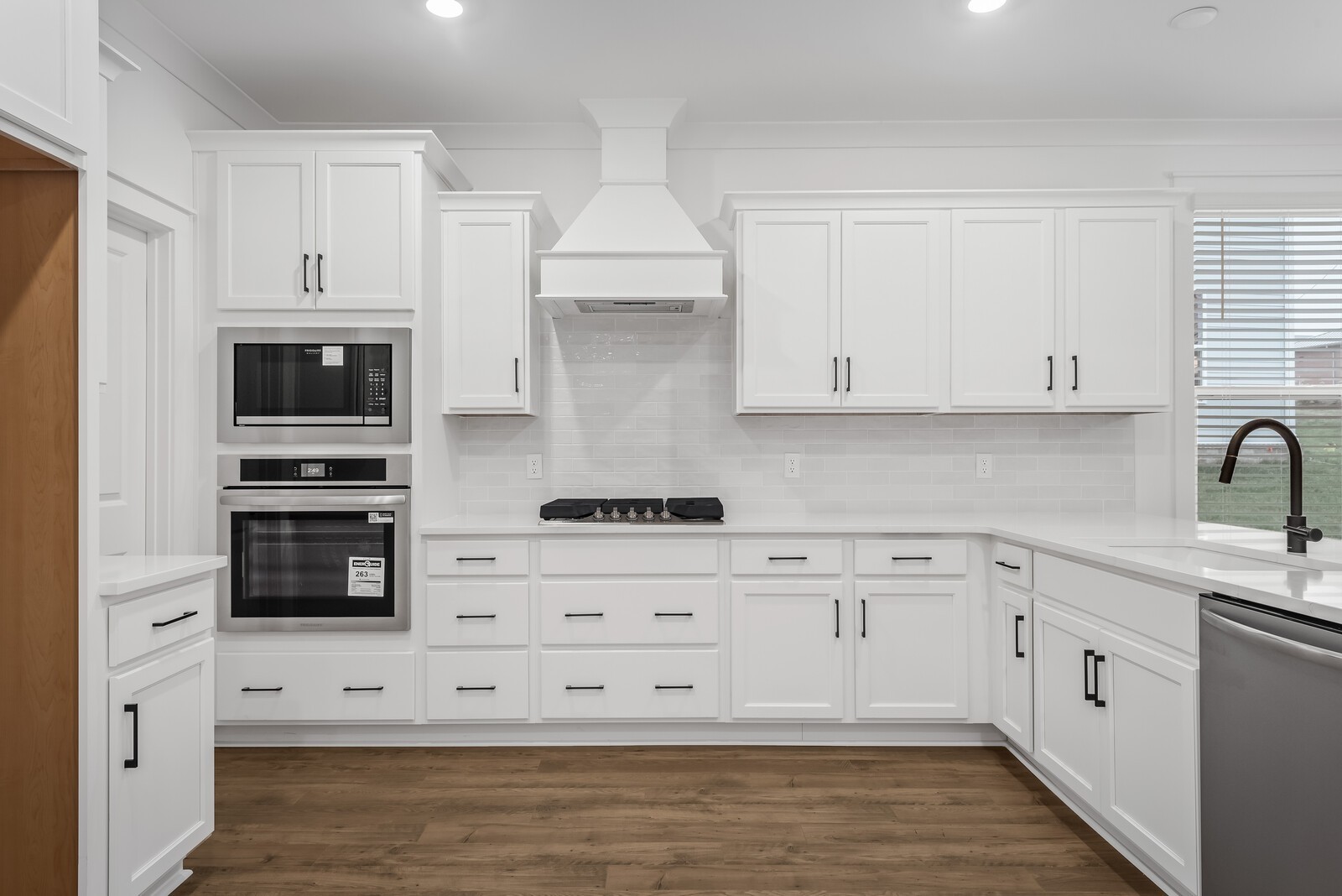 666 Conifer Drive Spring Hill, TN 37174 - Photo 37 of 64 a kitchen with stainless steel appliances white cabinets and a stove a oven with white countertops