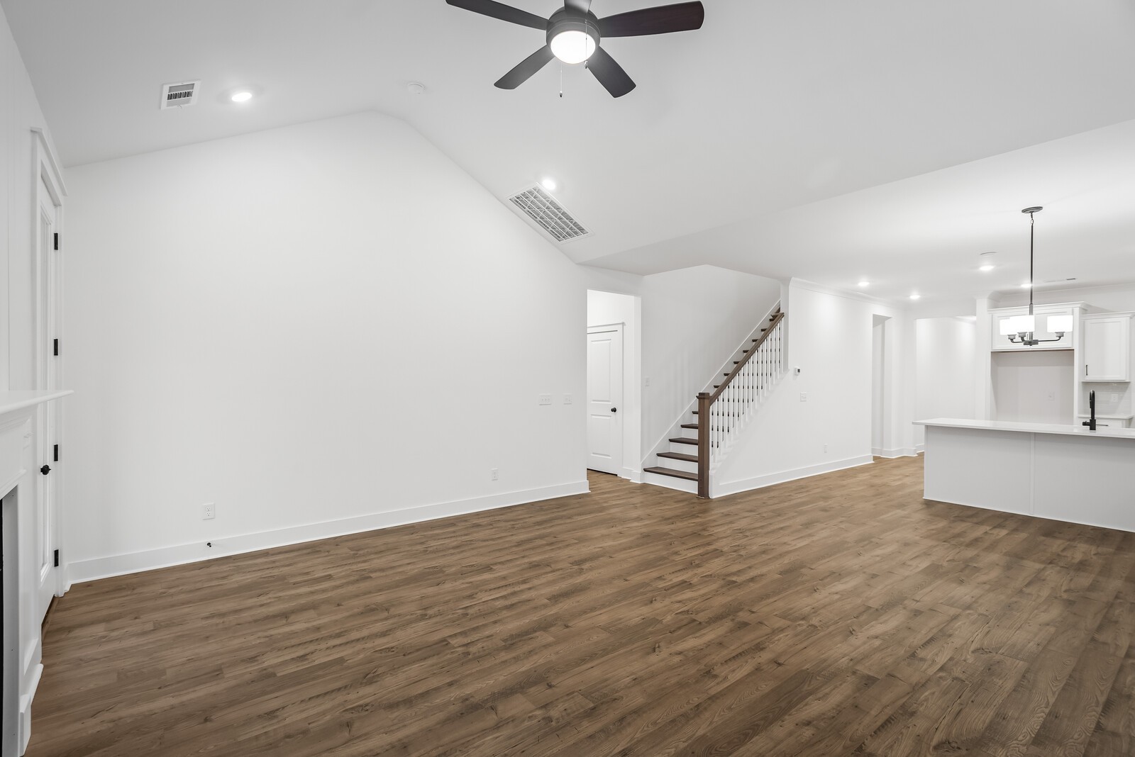 666 Conifer Drive Spring Hill, TN 37174 - Photo 42 of 64 a view of an empty room with wooden floor a ceiling fan and kitchen view