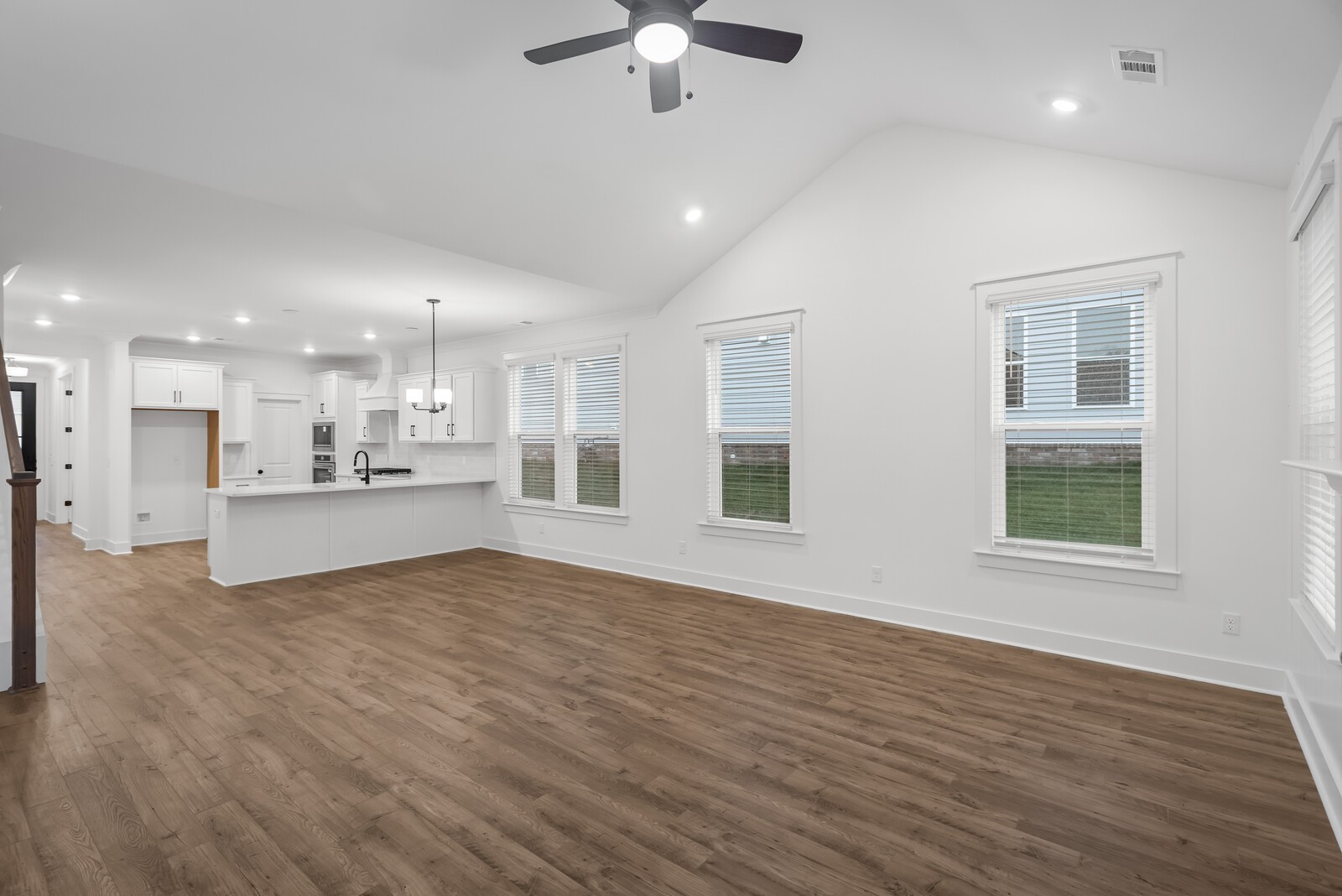 666 Conifer Drive Spring Hill, TN 37174 - Photo 43 of 64 a view of an empty room with wooden floor and a kitchen