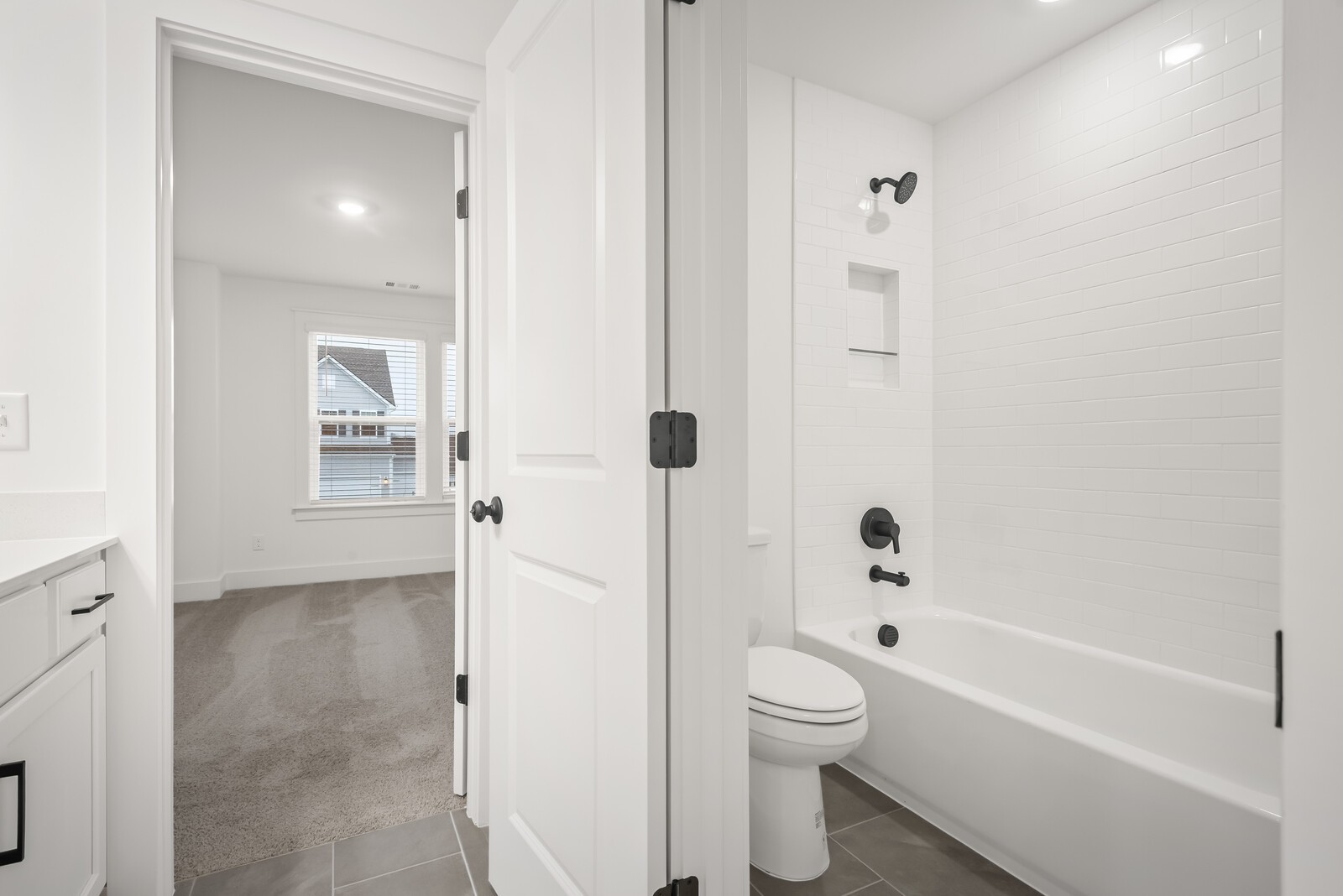666 Conifer Drive Spring Hill, TN 37174 - Photo 63 of 64 a bathroom with a granite countertop toilet a sink and bathtub