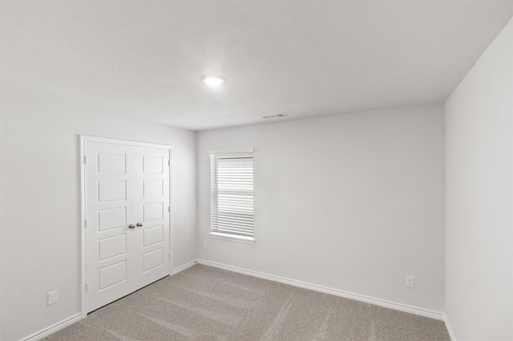 1009 Wind Drift Way Fort Worth, TX 76131 - Photo 15 of 40 an empty room with windows and closet