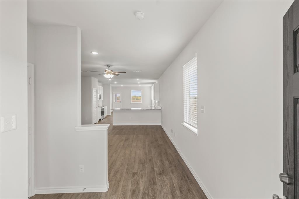 1009 Wind Drift Way Fort Worth, TX 76131 - Photo 3 of 40 wooden floor in an empty room with a window