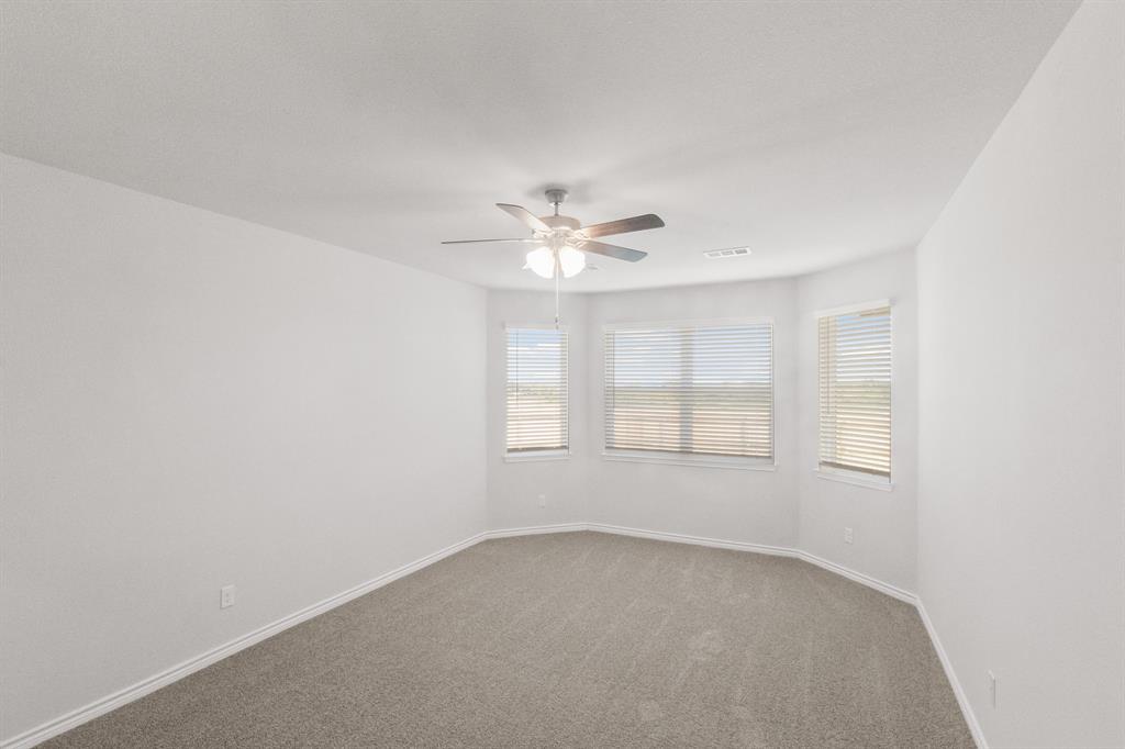 1009 Wind Drift Way Fort Worth, TX 76131 - Photo 7 of 40 an empty room with a window and a ceiling fan