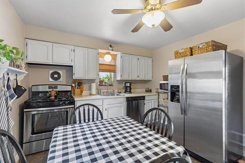 213 Logan Road Bethel Park, PA 15102 - Photo 11 of 47 a kitchen with a sink stove and refrigerator