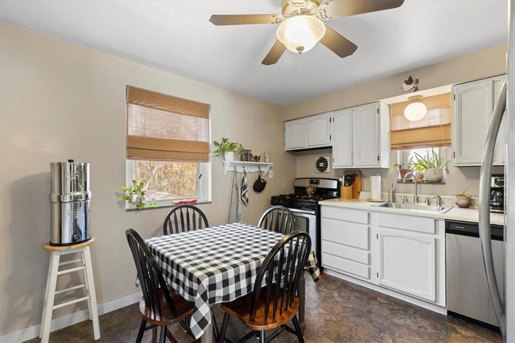 213 Logan Road Bethel Park, PA 15102 - Photo 12 of 47 a kitchen with a dining table chairs stainless steel appliances and cabinets