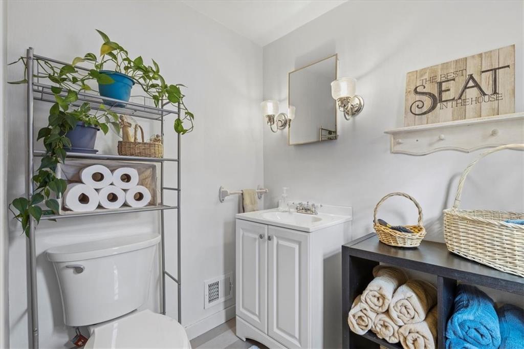 213 Logan Road Bethel Park, PA 15102 - Photo 24 of 47 a bathroom with a toilet sink and mirror