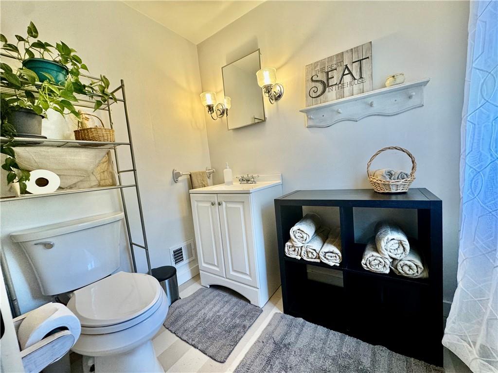 213 Logan Road Bethel Park, PA 15102 - Photo 26 of 47 a bathroom with a toilet a sink and mirror