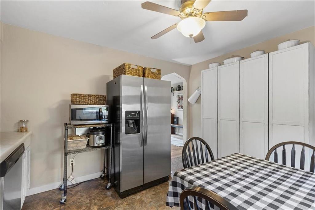 213 Logan Road Bethel Park, PA 15102 - Photo 9 of 47 a kitchen with stainless steel appliances a refrigerator a stove a sink dishwasher with a dining table and chairs