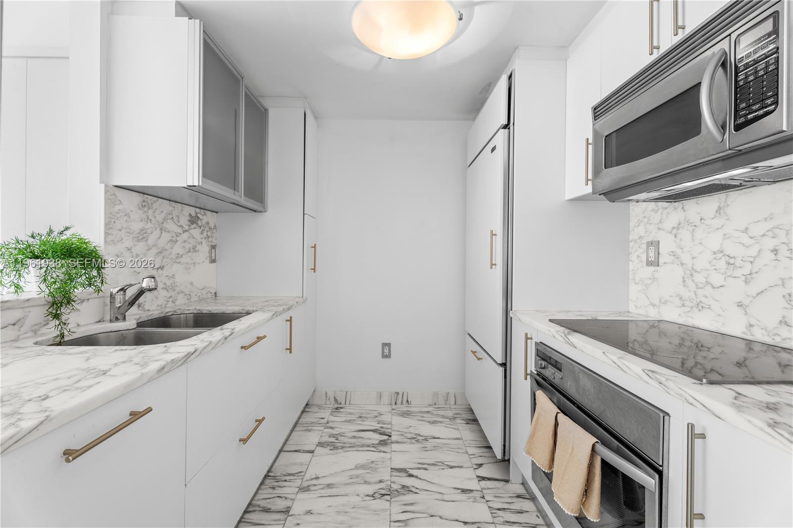 450 Alton Road, Unit 3008 Miami Beach, FL 33139 - Photo 5 of 34 a kitchen with stainless steel appliances granite countertop a sink stove and microwave