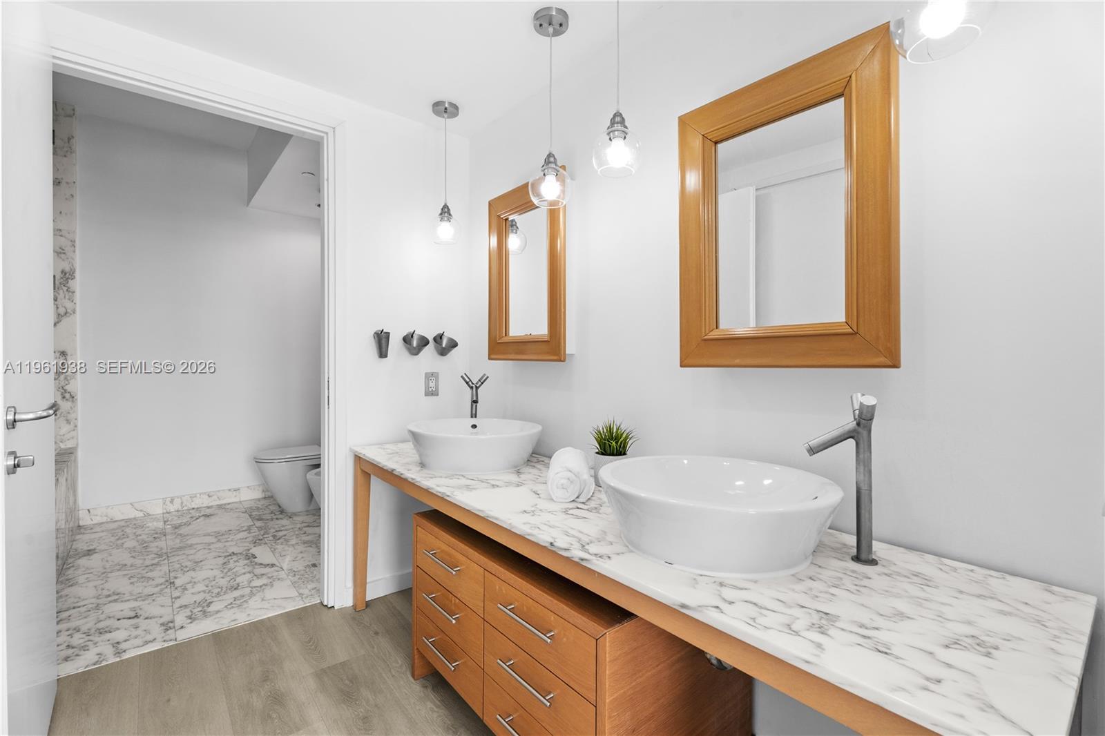 450 Alton Road, Unit 3008 Miami Beach, FL 33139 - Photo 10 of 34 a bathroom with a sink and a mirror