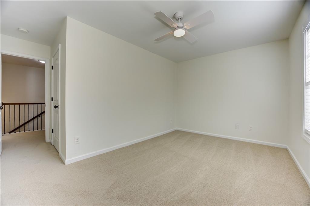 605 Summit Point Canton, GA 30114 - Photo 40 of 56 an empty room with a ceiling fan and a window