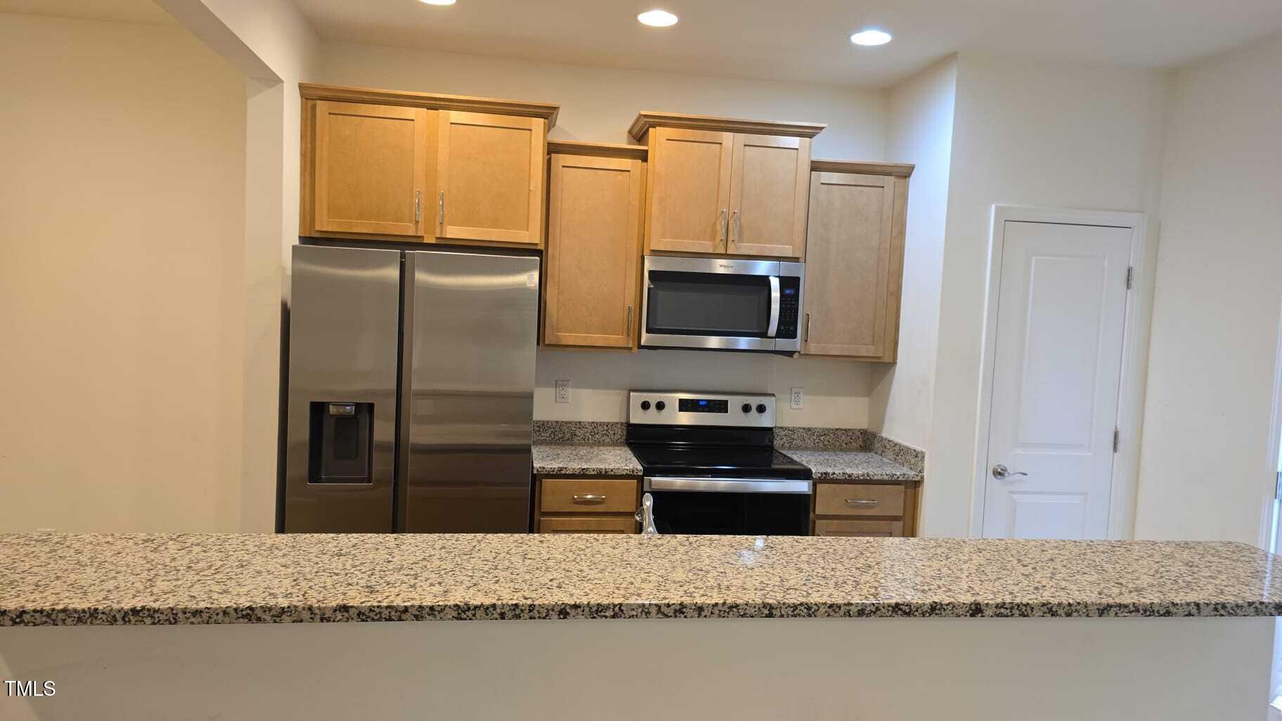 Undisclosed Address Raleigh, NC 27610 - Photo 6 of 12 a kitchen with stainless steel appliances granite countertop a refrigerator a stove and a sink