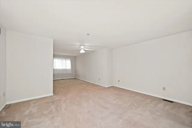 an empty room with a empty space and windows