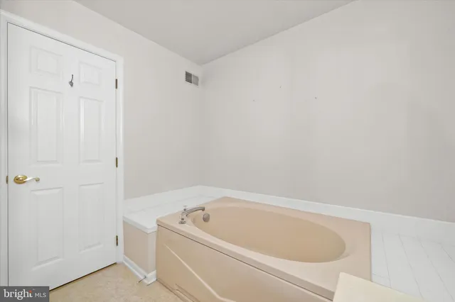 a white bath tub sitting in a bathroom