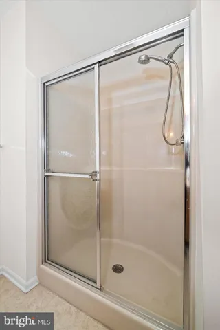 a bathroom with a glass shower door