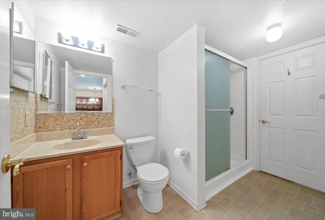 a bathroom with a toilet sink and shower