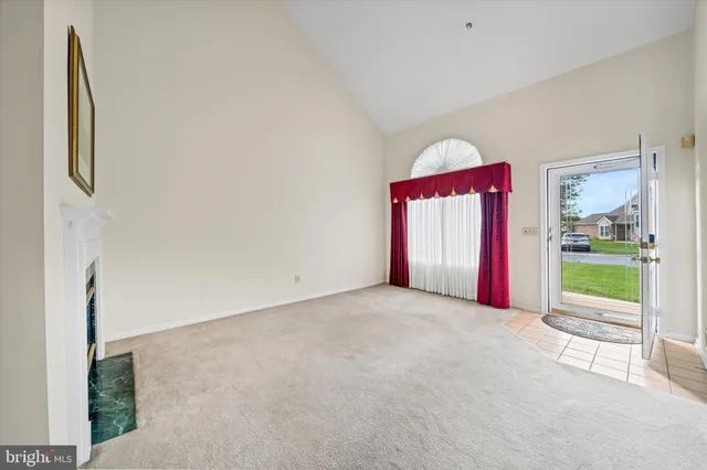 a view of an empty room with a fireplace