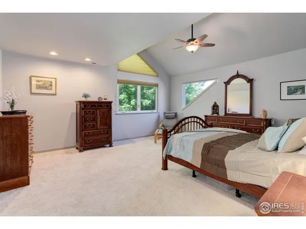 a spacious bedroom with a bed and a chandelier