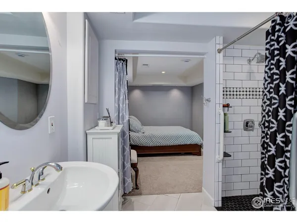 a bathroom with a tub sink and mirror
