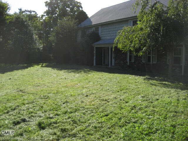 a backyard of a house with lots of green space