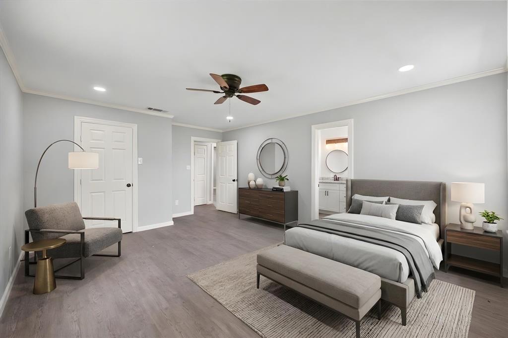 1009 North Spikes Road Corsicana, TX 75110 - Photo 10 of 31 a spacious bedroom with a bed a couch and a ceiling fan