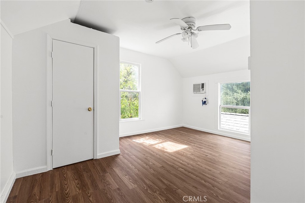 818 6th Street Corning, CA 96021 - Photo 22 of 32 an empty room with wooden floor chandelier fan and windows