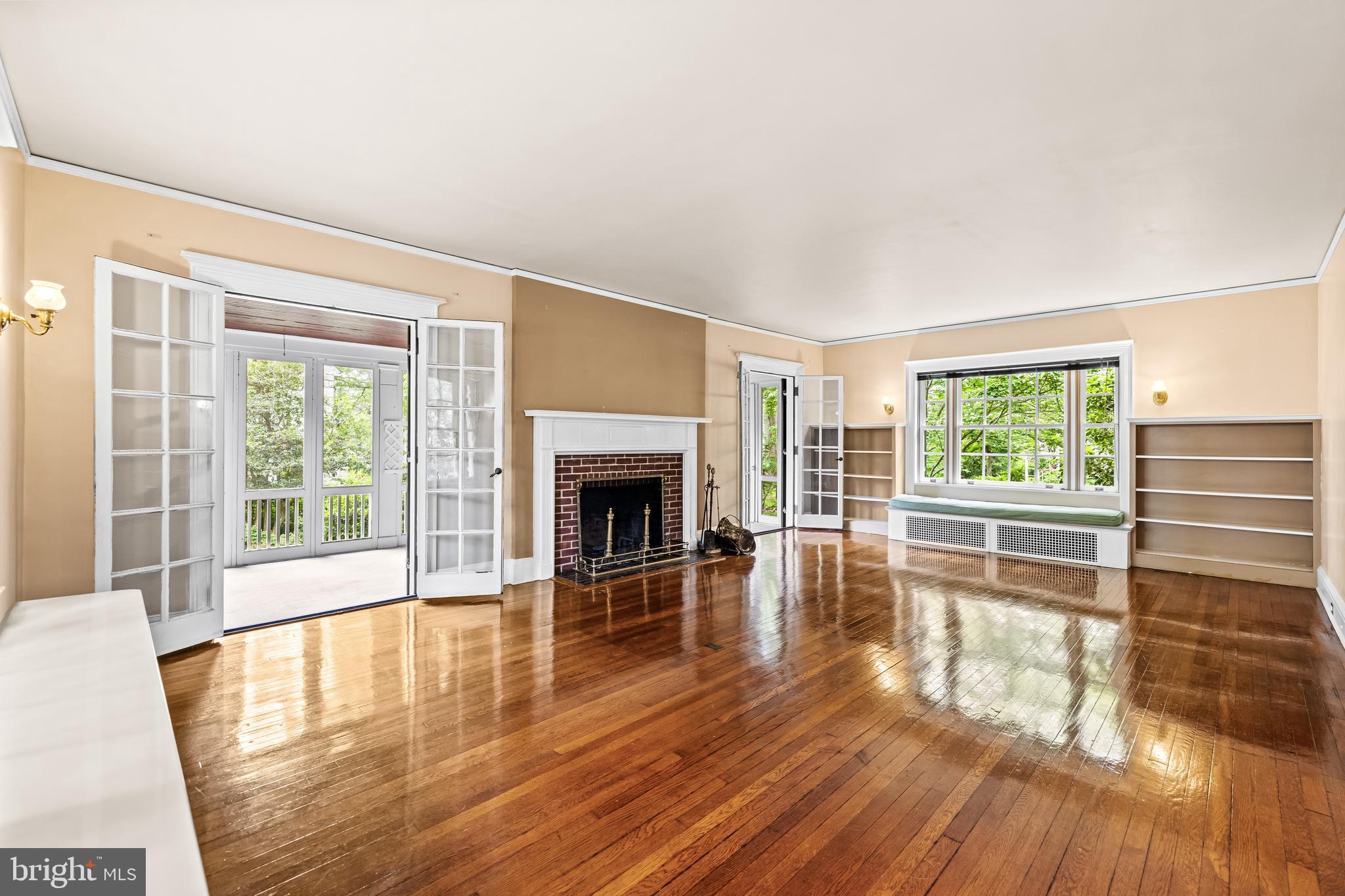 4406 Norwood Road Baltimore, MD 21218 - Photo 11 of 74 a view of empty room with wooden floor and fireplace