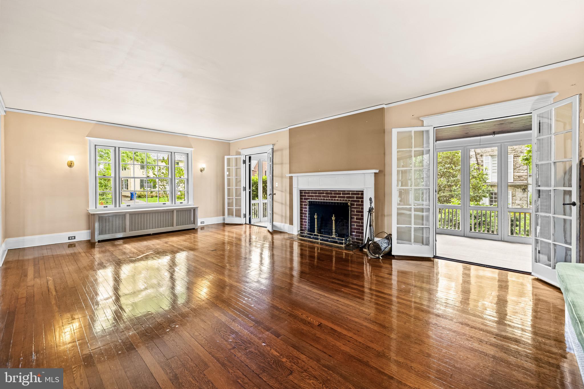 4406 Norwood Road Baltimore, MD 21218 - Photo 13 of 74 a view of empty room with wooden floor and fireplace