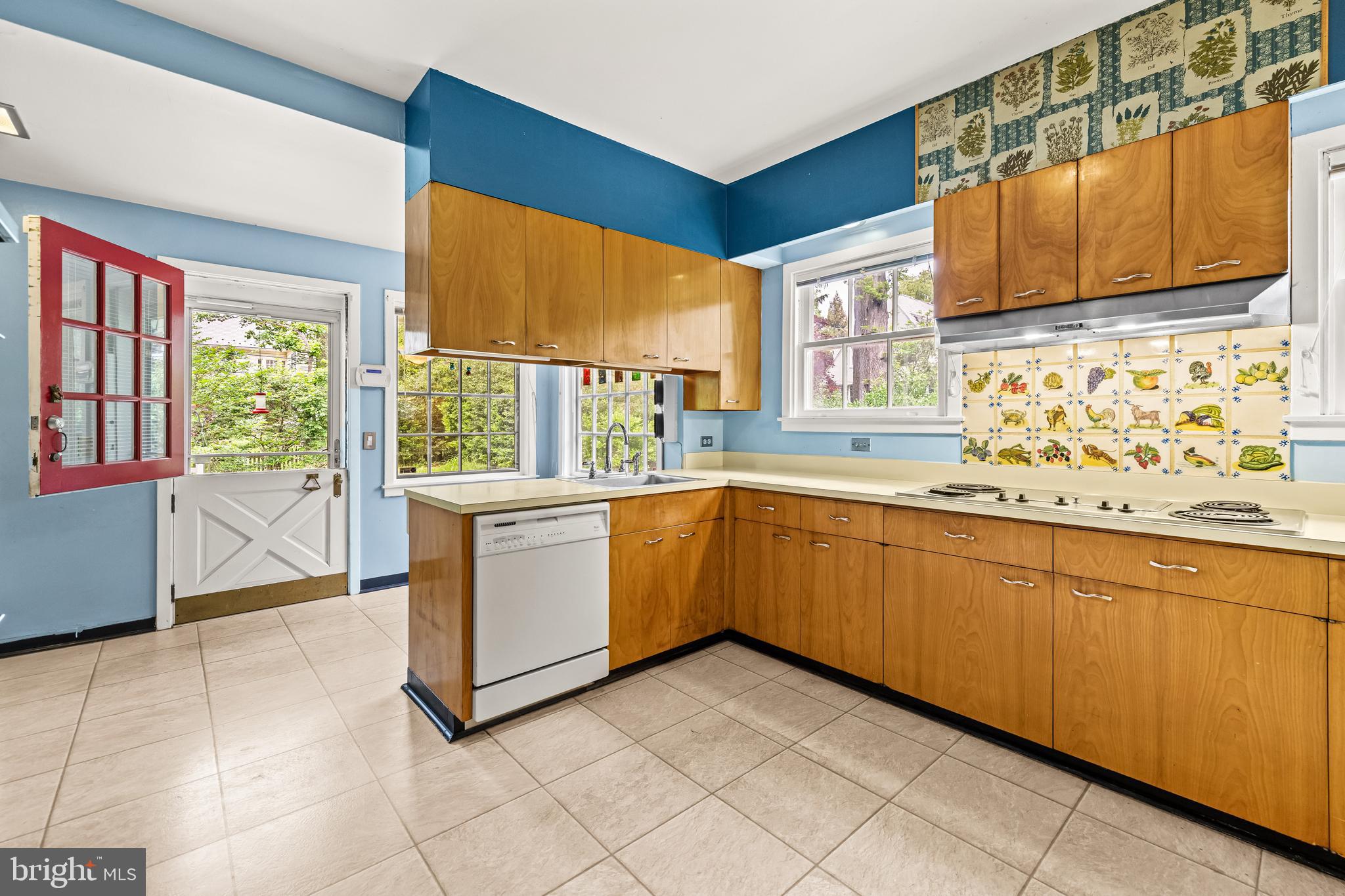 4406 Norwood Road Baltimore, MD 21218 - Photo 26 of 74 a kitchen with granite countertop a stove a sink and a window