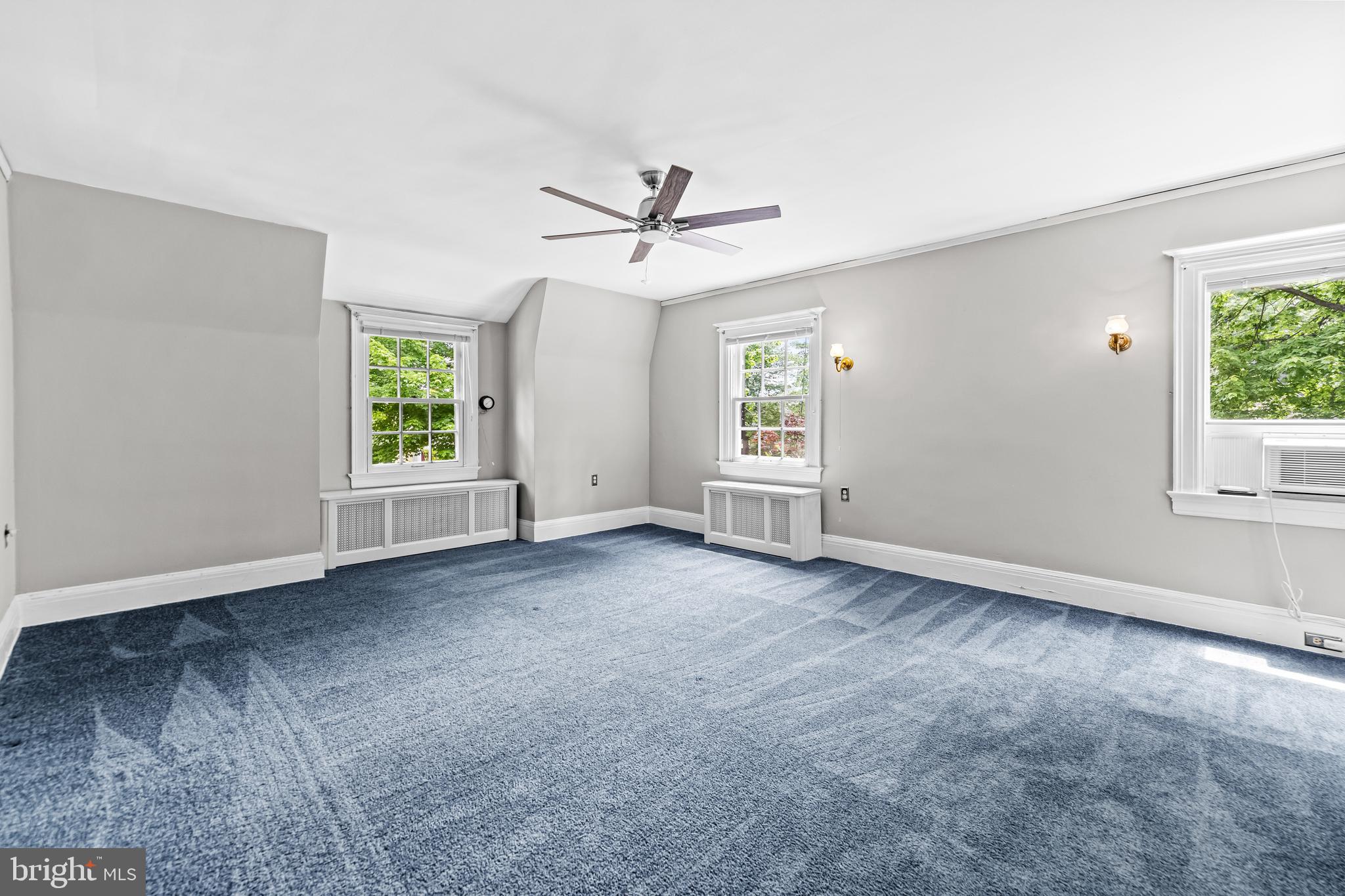 4406 Norwood Road Baltimore, MD 21218 - Photo 35 of 74 an empty room with windows and ceiling fan view