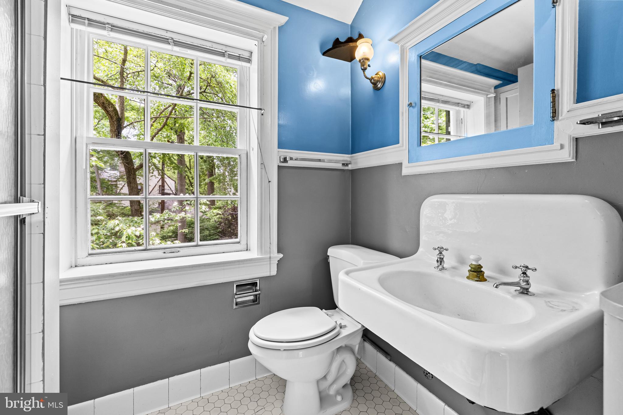 4406 Norwood Road Baltimore, MD 21218 - Photo 38 of 74 a bathroom with a sink a toilet and a mirror