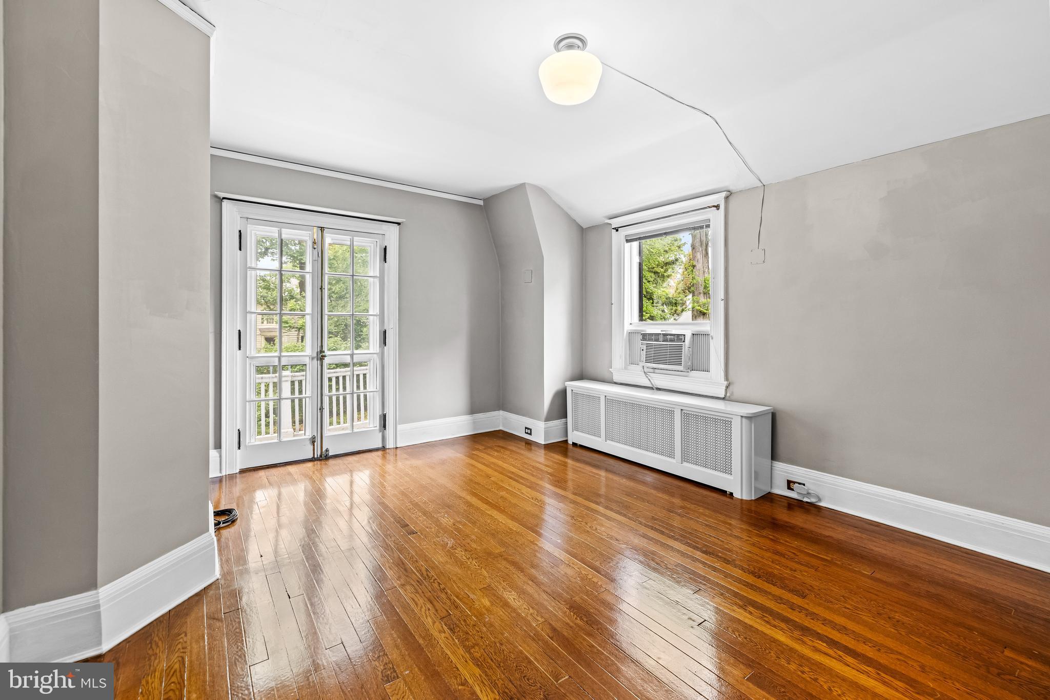 4406 Norwood Road Baltimore, MD 21218 - Photo 46 of 74 a view of an empty room with wooden floor and a window