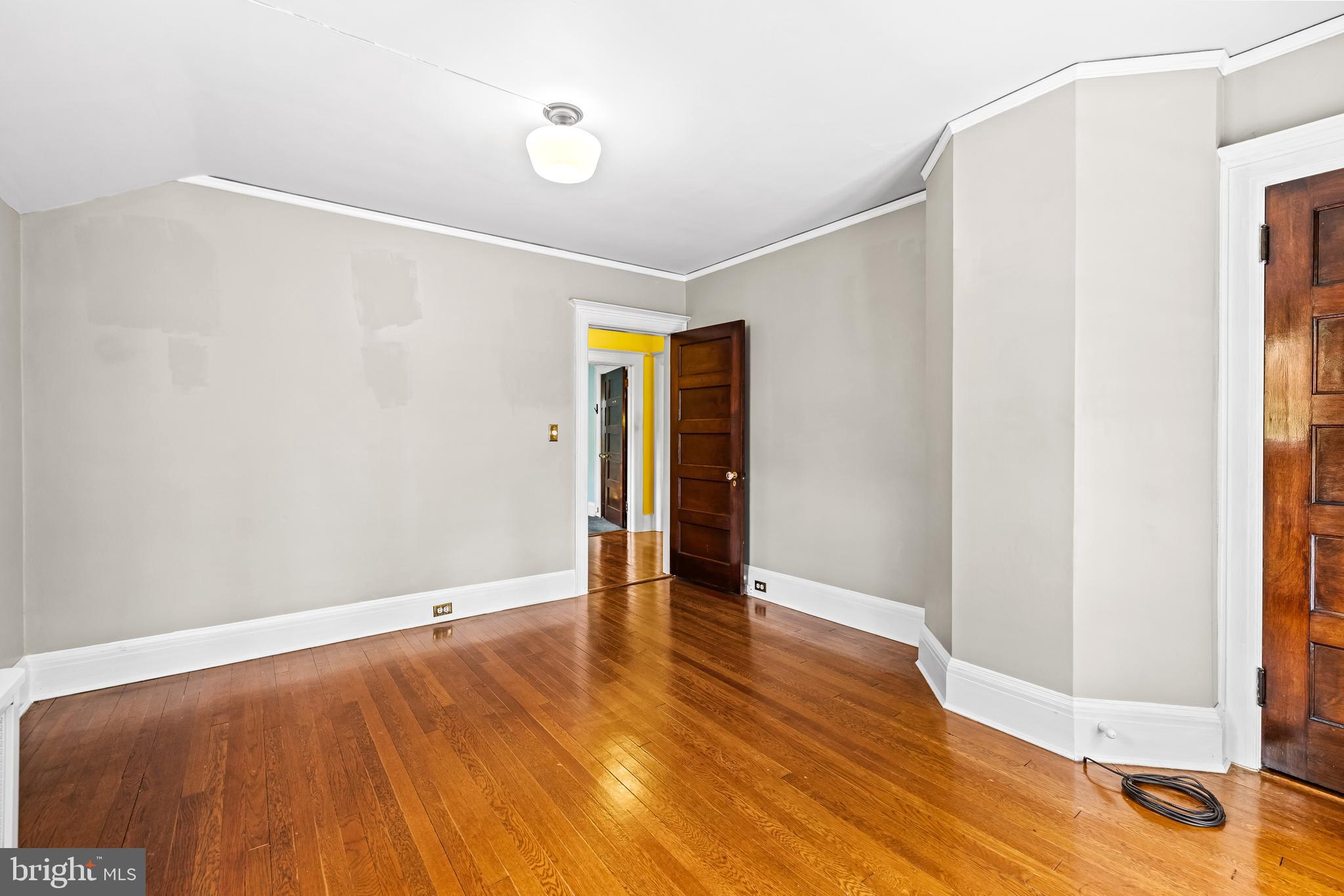 4406 Norwood Road Baltimore, MD 21218 - Photo 47 of 74 a view of an empty room with wooden floor