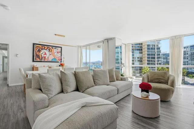 a living room with furniture and floor to ceiling window