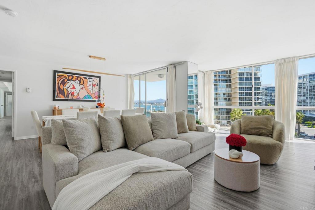 a living room with furniture and floor to ceiling window