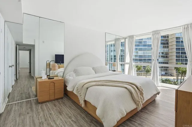 a bed room with a bed and a large window