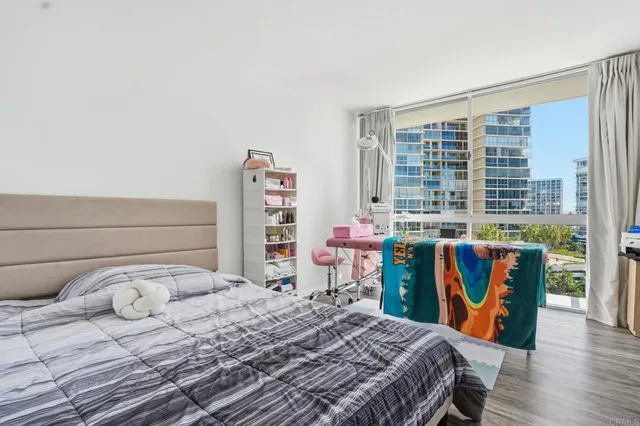 a bedroom with a bed a table and book shelf