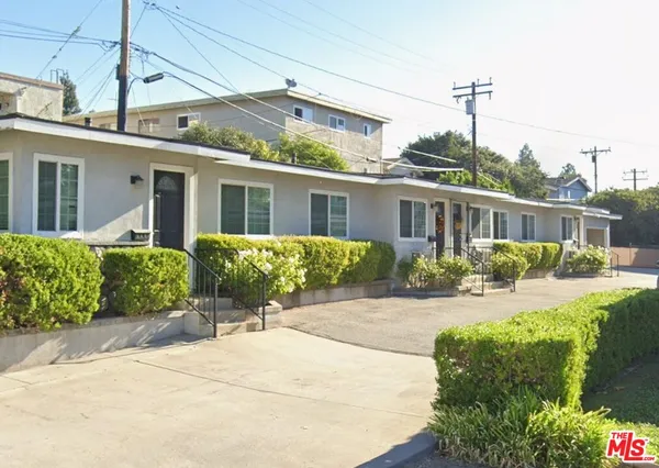 a front view of a house with yard and seating space