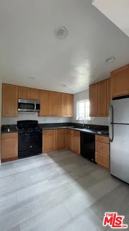 a kitchen with stainless steel appliances and a refrigerator