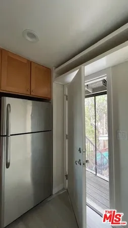 a view of a refrigerator in kitchen and wooden floor
