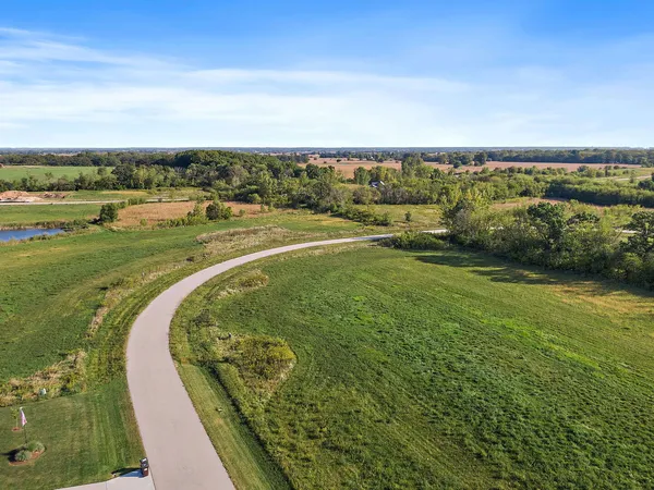 an aerial view of a golf course with a lake view