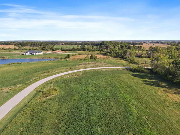 an aerial view of a houses with outdoor space and swimming pool