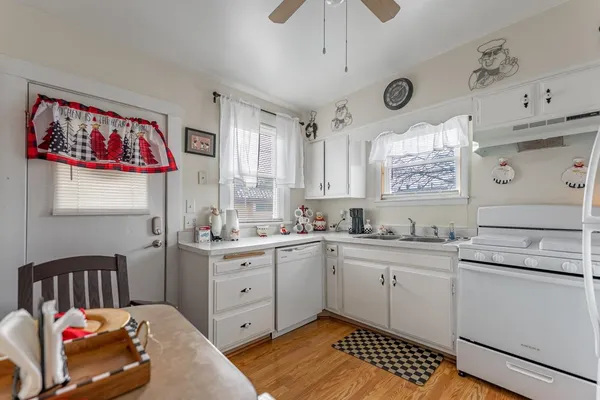 a kitchen with refrigerator and cabinets