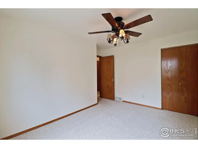 a view of a livingroom with furniture and an empty room