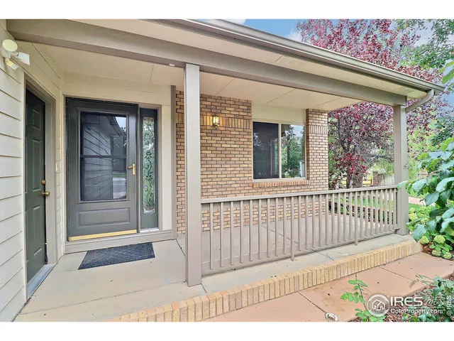 a view of a porch with a floor to ceiling window and wooden floor
